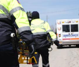 Paramedics with stretcher on roadside